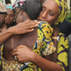 Nigerian Vice President Yemi Osinbajo (right) looks on while his wife Dolapo (center) comforts one of the 21 freed Chibok girls freed from Boko Haram, at his office in Abuja, Nigeria, Oct. 13, 2016.
PHILIP OJISUA/AFP/Getty Images